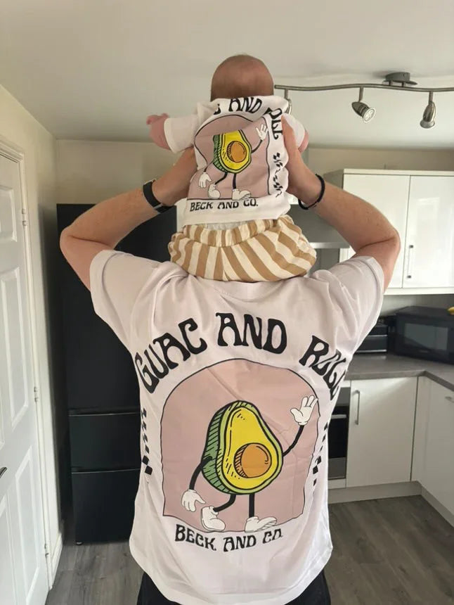 Adult and baby wearing matching Beck and Co. avocado streetwear shirts in a modern kitchen