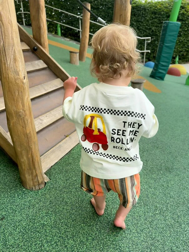 Child wearing a shirt with a graphic design on a playground