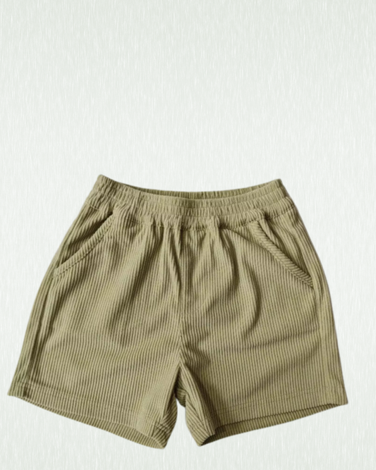 Kids green corduroy skate shorts on a white background