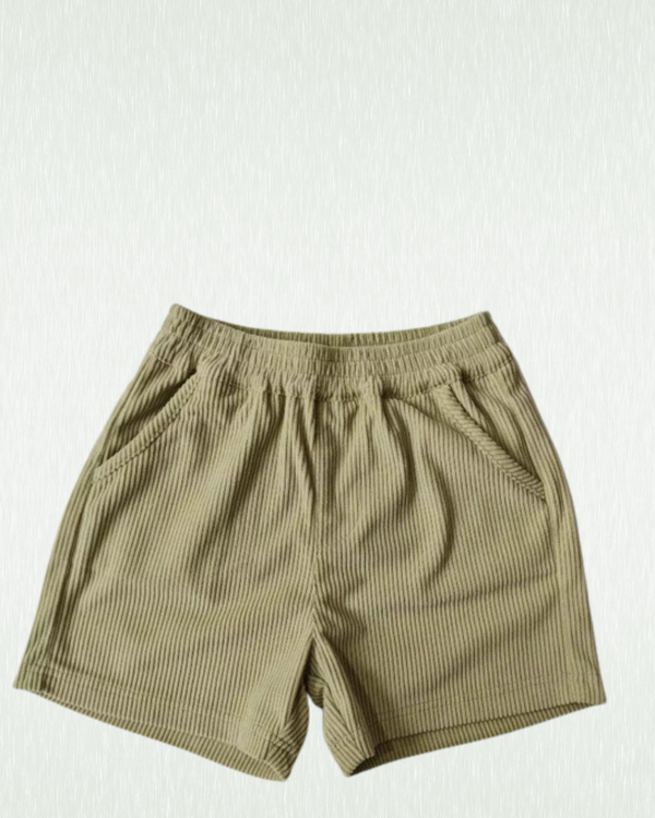 Kids green corduroy skate shorts on a white background