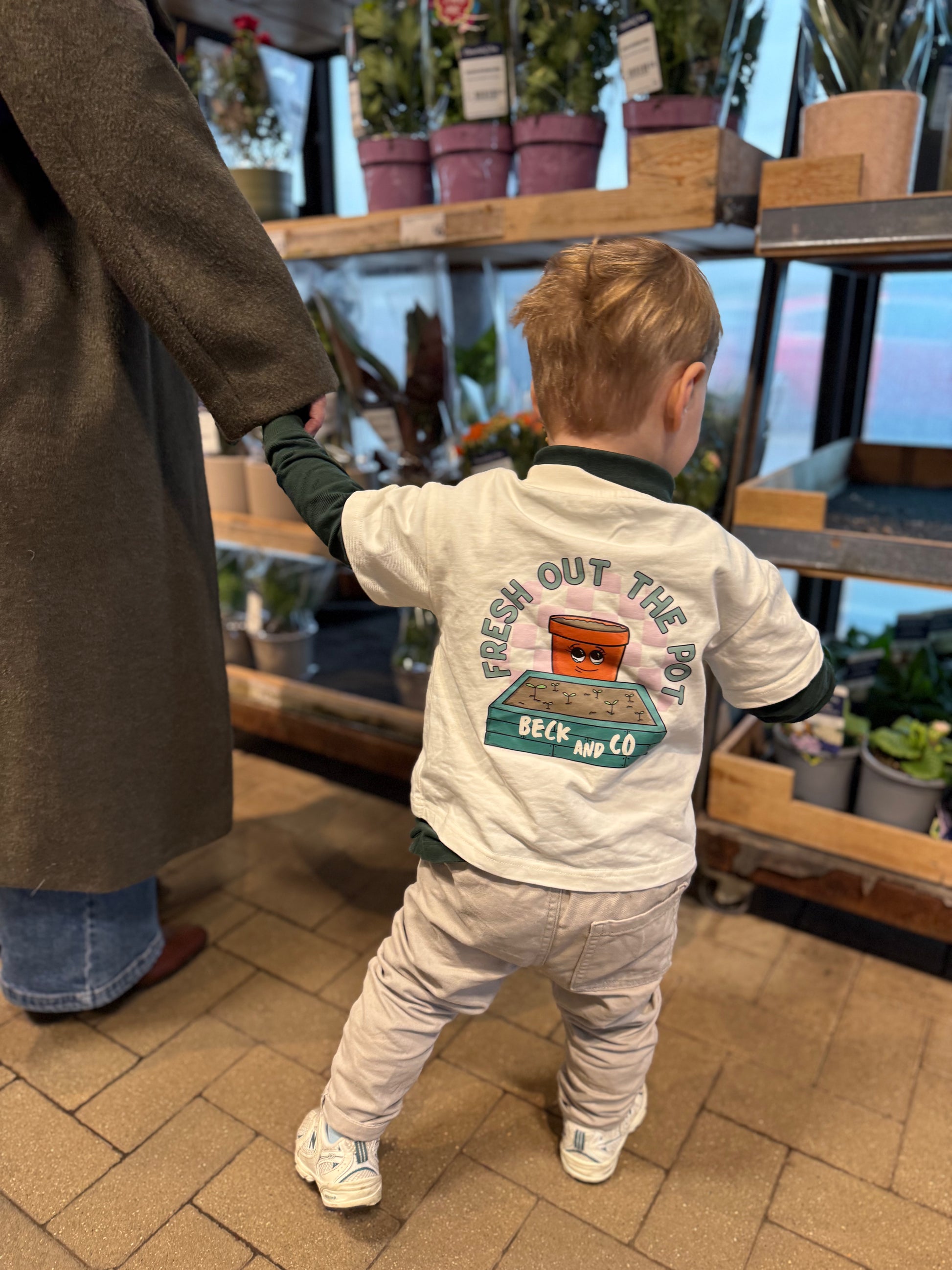 Child wearing a shirt with a graphic design in a store setting