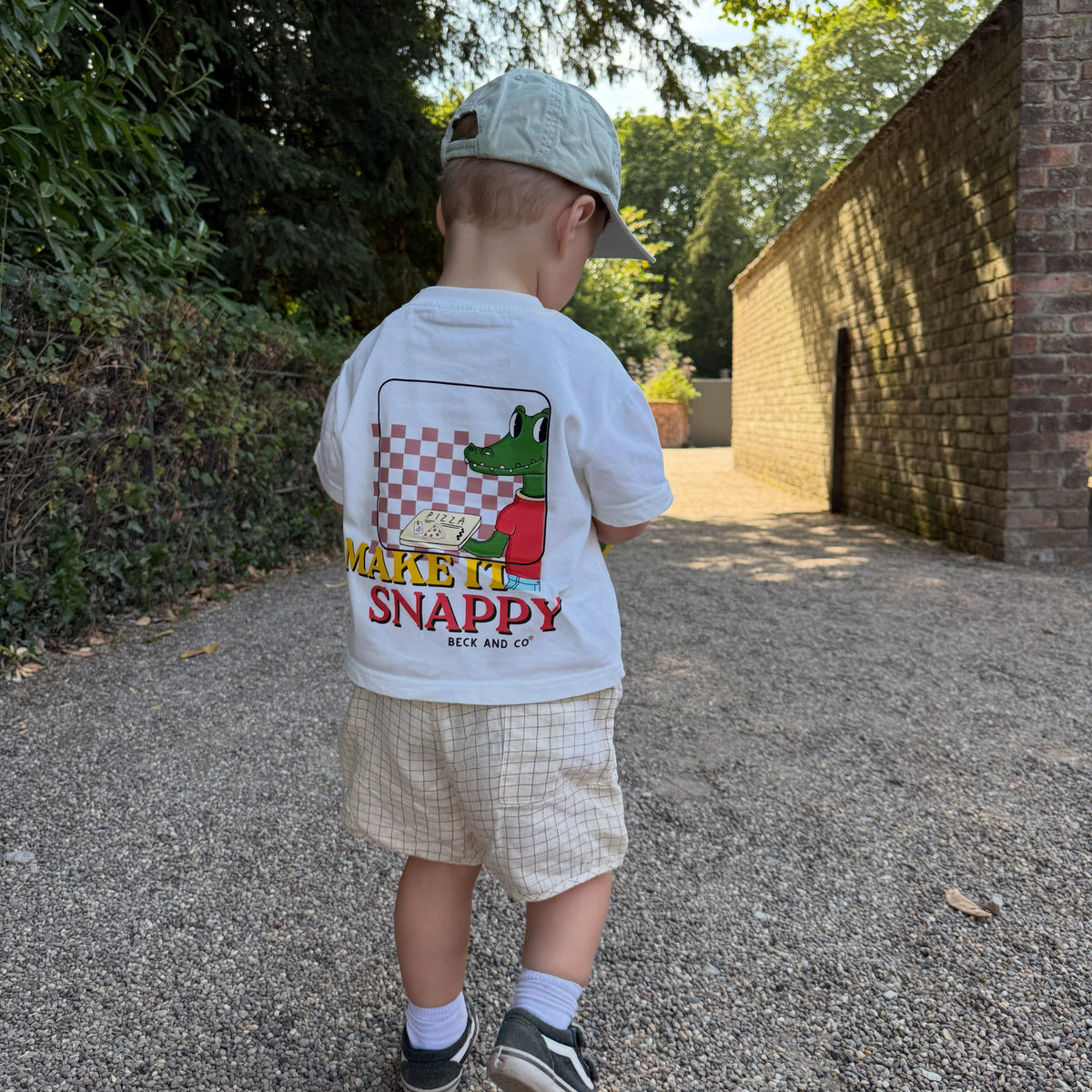 Make It Snappy oversized children’s t-shirt with crocodile pizza back print child wearing outdoors