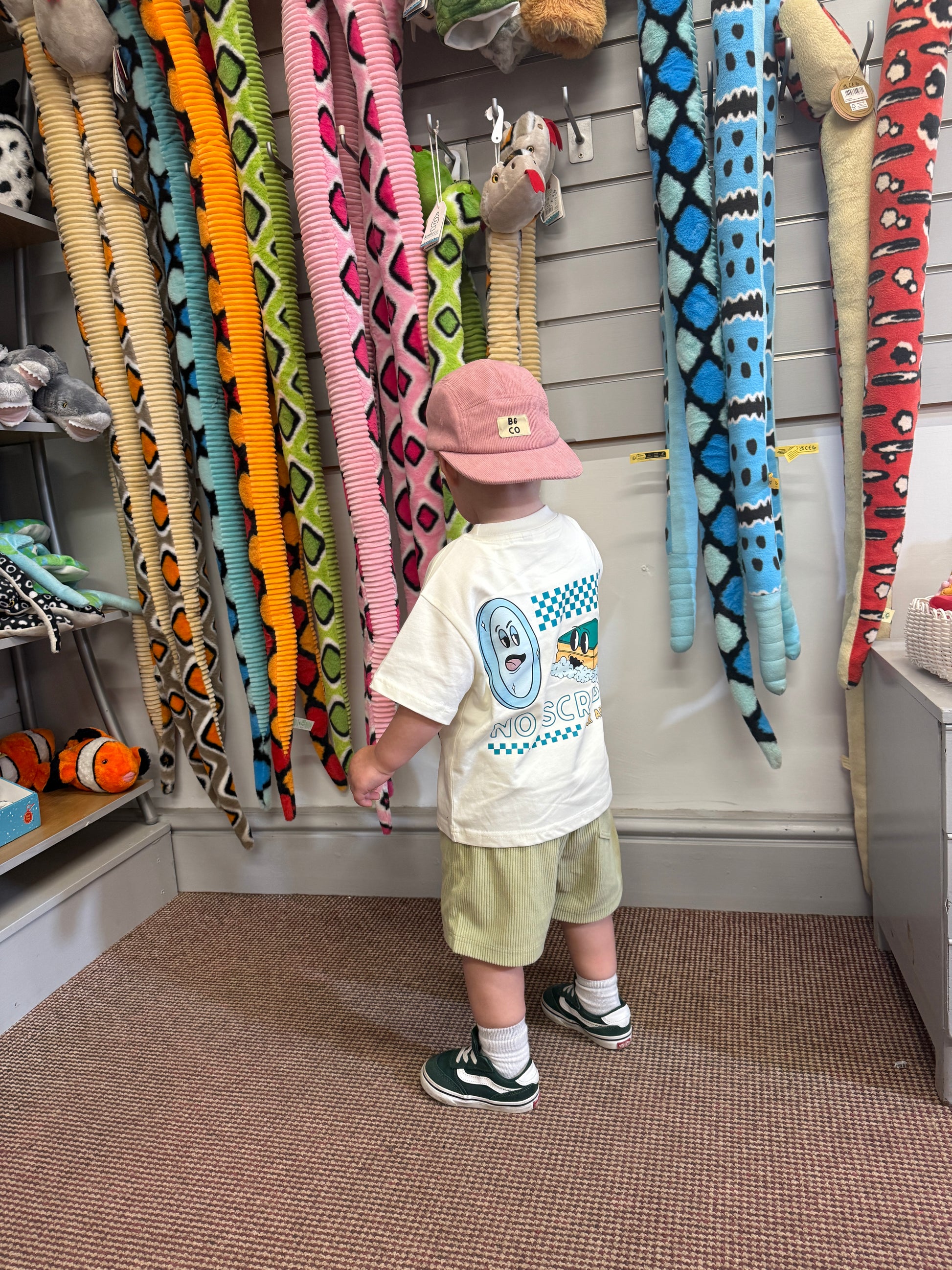 Child wearing skater cap backwards with corduroy skater shorts