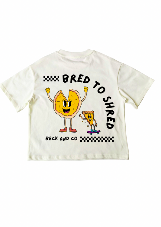 White t-shirt with cartoon characters and text 'Bred to Shred' on a white background